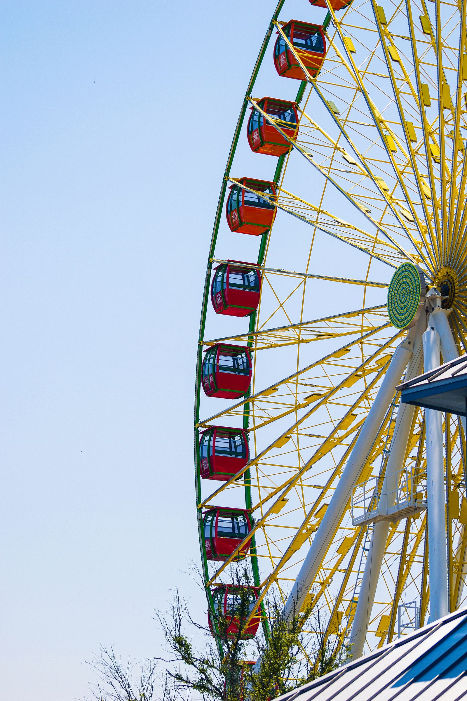 A Ferris wheel against a pale blue sky, photographed by Mike Loerop