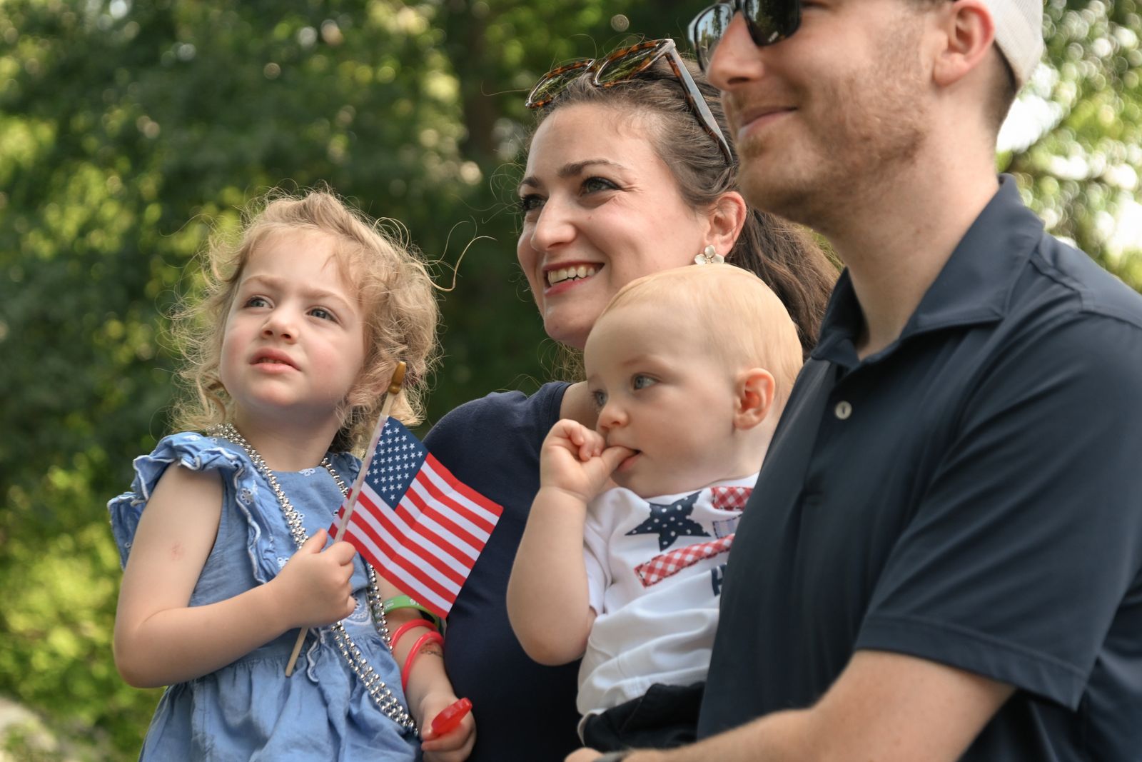 A family celebrating the Fourth of July with small American flags, photographed by Mike Loerop