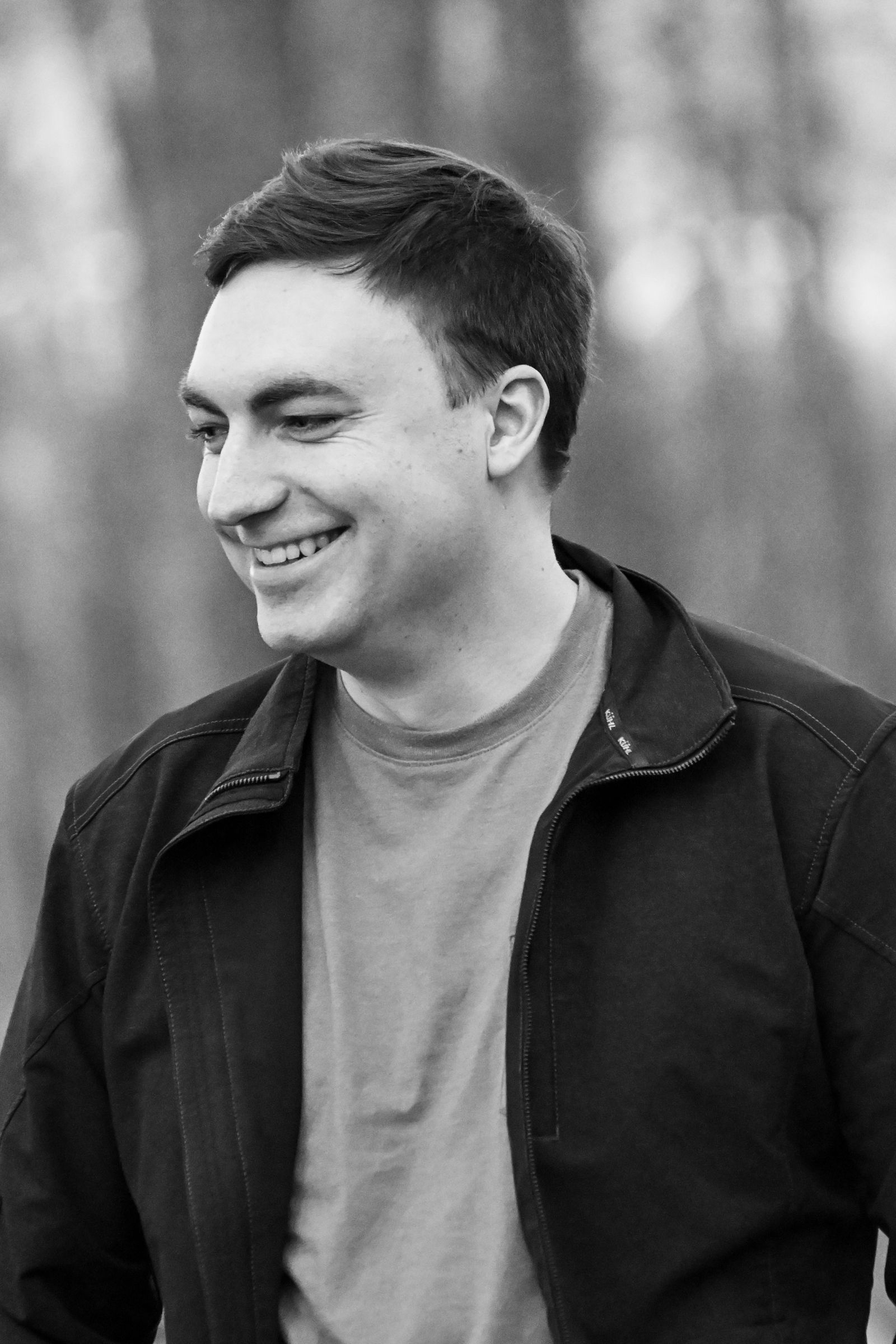 Black and white portrait of Mike Loerop laughing and looking down