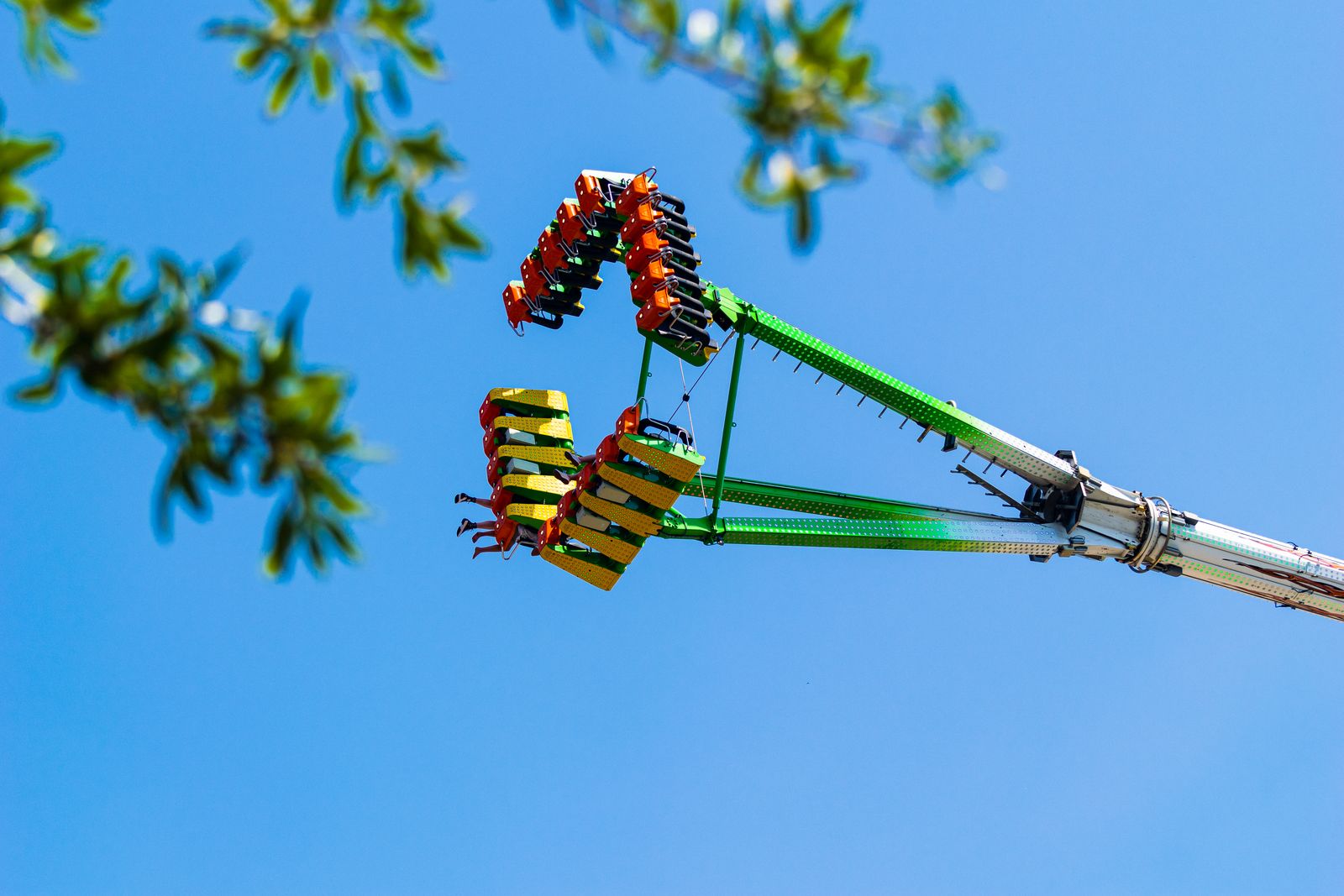 A spinning swing ride against a bright blue sky, photographed by Mike Loerop